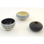 Three studio pottery bowls comprising a Buckfast Abbey blue and white bowl with stylised fern
