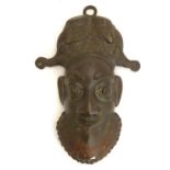Ethnographic / Native / Tribal : A 20thC cast African mask modelled as a male head with headdress.
