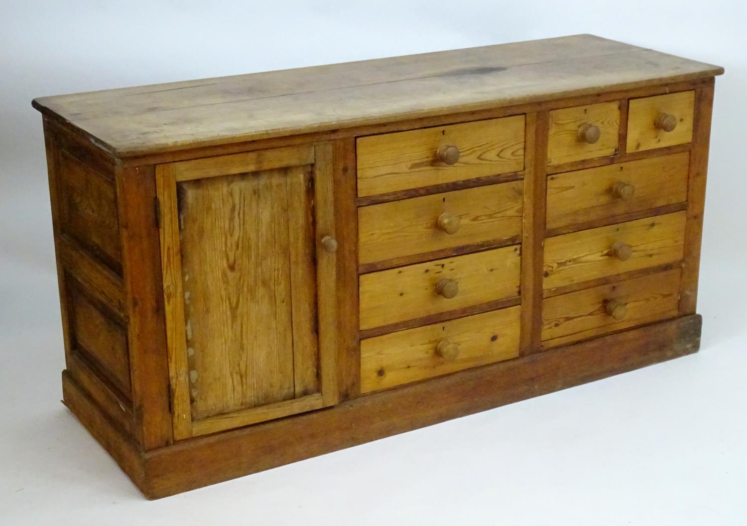A late 19thC pine dresser base with a moulded rectangular top above a single cupboard, seven short - Image 7 of 7