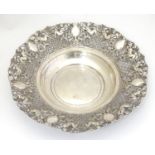 A silver plate dish with wide pierced rim with lattice and cherub detail. Approx 10 3/4" wide Please