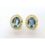 A pair of gold earrings set with facet cut aquamarine coloured stones. Approx. 3/8" long Please Note