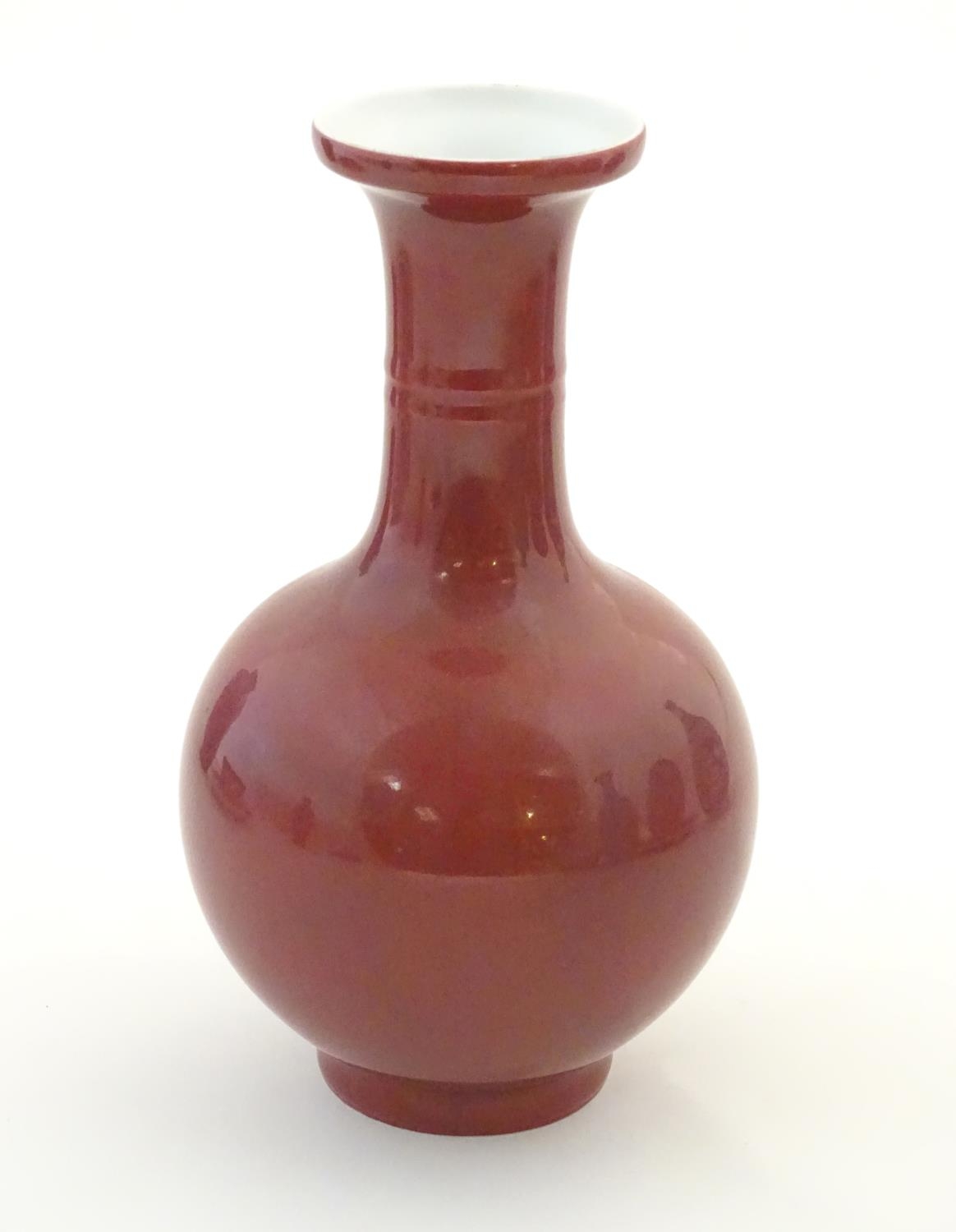 A Chinese bottle vase with a flared rim. Character marks under. Approx. 7 3/4" high Please Note - we