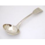 A Victorian silver Fiddle Pattern saucer ladle, hallmarked 1852, maker Chawner & Co. Approx. 7" long