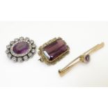 A 15ct gold bar brooch set with central amethyst. Together with another white metal example set with