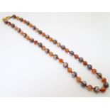 A necklace of venetian glass beads with gilt clas. Approx 24" long Please Note - we do not make