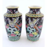 A pair of Oriental vases decorated with stylised pheasants amongst flowers. Character marks under.