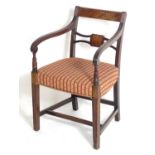 A Regency mahogany carver chair with a flame mahogany top rail and a shaped pierced mid rail, having