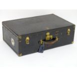 An early 20thC Oshkosh steamer trunk. the leather and wood case having studwork detailing and