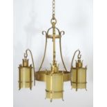 A 20thC Arts & Crafts style pendant gilt ceiling light, with three branches, approximately 24"