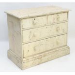 A late 19thC / early 20thC painted pine chest of drawers with a moulded top above two short over two