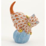 A Herend pottery model of a cat with a ball of string / wool with fishnet decoration and gilt