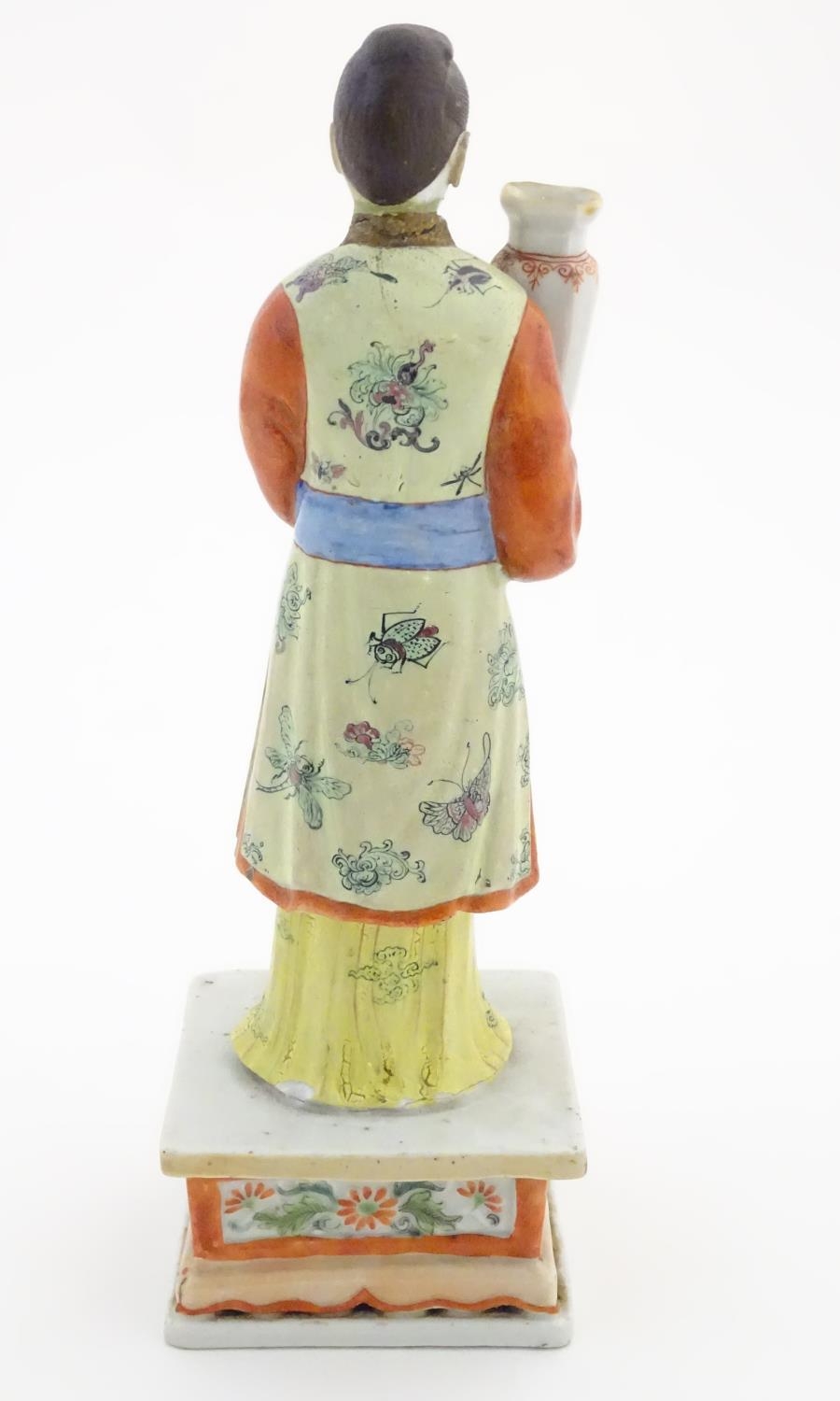 An Oriental porcelain model of a male figure wearing a kimono with butterfly and floral detail - Image 5 of 8