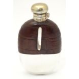 A glass hip flask of ovoid form with half leather covering and silver mount, hallmarked Sheffield