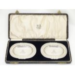 Military Interest : A cased pair of silver ashtrays with engraved Royal Artillery insignia to centre