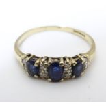 A 9ct gold ring set with trio of sapphires and chip set diamonds ring size approx. N Please Note -