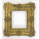 A late 19th / early 20thC cast metal frame with moulded floral and foliate detail and wooden