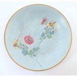 A Chinese plate with stylised peony flower detail. Character marks under. Approx. 6" diameter Please