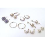 A quantity of assorted silver and white metal earrings to include examples set with amethyst,