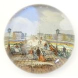 An early 20thC glass souvenir paperweight depicting figures on Wellington Pier, Yarmouth, Norfolk.