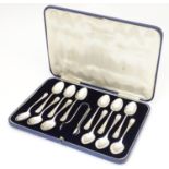 A cased set of 12 silver plate teaspoons with sugar tongs en suite. Please Note - we do not make