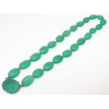 A vintage bead necklace comprising 23 green jade coloured ovoid beads with engraved clasp and .935