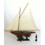 A 20thC model / pond yacht / boat of large proportions, carvel constructed from mahogany planks with