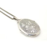 A silver and white metal locket and chain. Approx. 25" long overall Please Note - we do not make