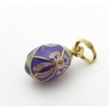 A Russian silver gilt pendant / charm formed as an egg with enamel decoration. Approx. 1/2" long