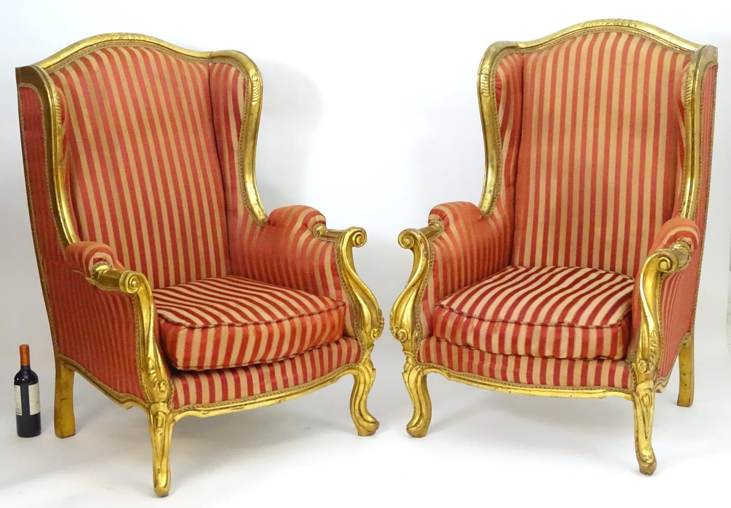 A pair of mid 20thC large gilt wingback armchairs, having moulded frames with floral decoration, - Image 4 of 7