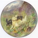 A Victorian charger with hand painted decoration depicting terrier dogs in a landscape in the manner