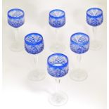 A set of six early 20thC Hock glasses, with clear glass feet and stems, the bowls decorated with