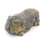 An Oriental model of a recumbent animal, possibly a cat. Marked under. Approx. 9" long Please Note -
