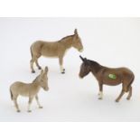 Three Beswick donkeys comprising model numbers 1364A, 1364B and 2110. Marked under. Largest