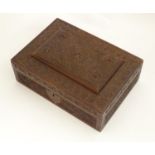 An early 20thC carved wooden box with scrolling floral and foliate decoration and banded flower