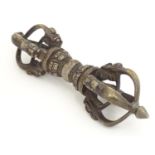 A bronze Tibetan Buddhist vajra / dorje, a ceremonial sceptre. The central knop with a seated