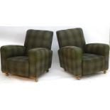 A pair of Art Deco club chairs with tartan style upholstery and raised on ball castors. 33" wide x