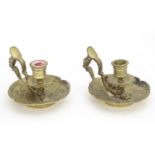 A pair of 19thC brass chambersticks with aesthetic bird decoration, winged beast support and mask