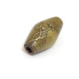 A Japanese ojime bead of oblong form with blossom detail. Approx. 6/8" Please Note - we do not