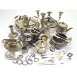 A large equanimity of assorted silver plated wares to include candlesticks, flatware, serving