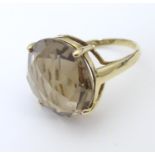 A 9ct gold dress ring set with facet cut citrine. the stone approx 3/4" diameter. Ring size approx R