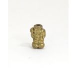 A Japanese brass ojime bead formed as a laughing figure. Approx. 5/8" Please Note - we do not make