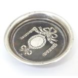 A white metal and tortoiseshell miniature dish with piquet style decoration. Approx. 1 1/2" diameter