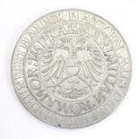 A replica of a Heller coin featuring the imperial eagle and the coat of arms of Schwabisch Hall.
