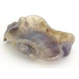 An Oriental carved amethyst coloured hardstone brush wash dish formed as a stylised lotus leaf and