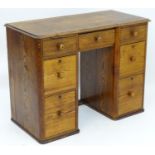 A mid / late 19thC pine desk with a moulded top above two banks of three graduated drawers