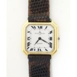 A Baume & Mercier wrist watch, the 18ct gold case of squared canted form with 7/8" dial, the reverse