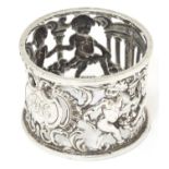 A Victorian silver napkin ring / salt frame with classical temples, putti etc., hallmarked