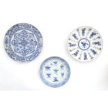 Three assorted Oriental blue and white plates, comprising a Chinese plate decorated with central