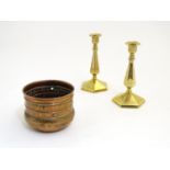 A pair of Victorian brass candlesticks of hexagonal form, together with a hammered copper pot with