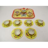 Toys: A 20thC Chad Valley tinplate tea set in bright yellow decorated with sprays of flowers and